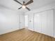 Bright bedroom featuring modern ceiling fan, light wood flooring, and closet at 10408 Rosemount Dr, Tampa, FL 33624