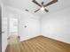Bedroom featuring wood floors, ceiling fan, and view into the bathroom at 10408 Rosemount Dr, Tampa, FL 33624