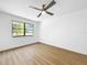 Bright bedroom featuring wood floors, ceiling fan, and natural light at 10408 Rosemount Dr, Tampa, FL 33624