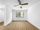Light filled bedroom with window overlooking trees and light wood flooring at 10408 Rosemount Dr, Tampa, FL 33624