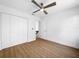 Bedroom featuring laminate floors, ceiling fan, and spacious closet at 10408 Rosemount Dr, Tampa, FL 33624