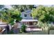 Charming two-story home with a screened-in porch and lush, mature trees surrounding the property at 10408 Rosemount Dr, Tampa, FL 33624