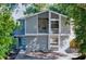 Charming two-story home with a unique architectural design and inviting curb appeal nestled among mature trees at 10408 Rosemount Dr, Tampa, FL 33624