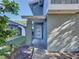 Inviting front entrance with a modern door and textured exterior, showcasing curb appeal at 10408 Rosemount Dr, Tampa, FL 33624