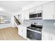 Modern kitchen featuring stainless steel appliances, white cabinets, and stylish backsplash at 10408 Rosemount Dr, Tampa, FL 33624