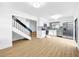 Bright open floor plan with modern kitchen featuring stainless steel appliances and staircase at 10408 Rosemount Dr, Tampa, FL 33624