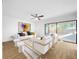 Bright living room featuring modern furniture, stylish decor, and an open layout that seamlessly flows to the outdoors at 10408 Rosemount Dr, Tampa, FL 33624