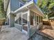 Screened-in porch with brick patio, offering a cozy and private outdoor space at 10408 Rosemount Dr, Tampa, FL 33624