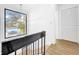 Bright staircase with black metal railing and large window with neighborhood views at 10408 Rosemount Dr, Tampa, FL 33624