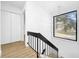 Contemporary staircase with black metal railing and large window at 10408 Rosemount Dr, Tampa, FL 33624