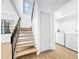 Staircase leading to the second floor with laundry room access at 10408 Rosemount Dr, Tampa, FL 33624