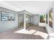 Sunroom showcasing sliding glass doors, tile floor, and backyard view at 10408 Rosemount Dr, Tampa, FL 33624