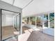 Enclosed sunroom with tile flooring and multiple windows offering natural light and outdoor views at 10408 Rosemount Dr, Tampa, FL 33624