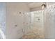 Hallway featuring tiled floors and several white doors, creating a clean and well-maintained entrance to the building at 105 4Th Ne Ave # 218, St Petersburg, FL 33701