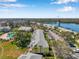 Aerial view of the condominiums featuring lush trees, parking area, and serene water views at 108 Pompano Se Dr # A, St Petersburg, FL 33705