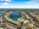 Beautiful aerial view of the community showcasing a scenic pond with fountain and a sparkling swimming pool at 108 Pompano Se Dr # A, St Petersburg, FL 33705