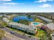 Aerial view of the condominium community showcasing the serene lake with fountain and well-kept grounds at 108 Pompano Se Dr # A, St Petersburg, FL 33705