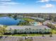 Community aerial view showing a serene lake with fountain, pool area, and well-maintained condominium buildings at 108 Pompano Se Dr # A, St Petersburg, FL 33705