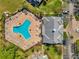 Aerial view of the community pool and amenity center with lounge chairs and patio furniture at 108 Pompano Se Dr # A, St Petersburg, FL 33705