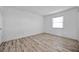 Bedroom featuring hardwood floors, neutral walls, and window with natural light at 108 Pompano Se Dr # A, St Petersburg, FL 33705