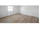 Bright bedroom featuring light wood-look flooring and a window at 108 Pompano Se Dr # A, St Petersburg, FL 33705