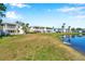 A view of the community buildings with balconies, surrounded by landscaping and lawns and lake at 108 Pompano Se Dr # A, St Petersburg, FL 33705