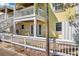 Brick patio and partial view of the yellow house with white trim and upper deck at 108 Pompano Se Dr # A, St Petersburg, FL 33705
