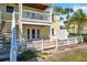 Charming two-story home with a white picket fence, balcony and a staircase leading to the upper level at 108 Pompano Se Dr # A, St Petersburg, FL 33705