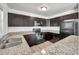 Kitchen features dark wood cabinets, stainless steel appliances, and granite countertops at 108 Pompano Se Dr # A, St Petersburg, FL 33705