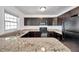 Kitchen showcasing dark wood cabinets, granite countertops, and modern stainless steel appliances at 108 Pompano Se Dr # A, St Petersburg, FL 33705