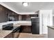 Updated kitchen featuring modern appliances, dark wood cabinets, and granite countertops at 108 Pompano Se Dr # A, St Petersburg, FL 33705