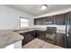 Modern kitchen with updated black appliances, granite counters, and a window at 108 Pompano Se Dr # A, St Petersburg, FL 33705