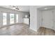 A bright living room with new flooring, and a view of the lake through the double doors at 108 Pompano Se Dr # A, St Petersburg, FL 33705