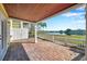 A brick paved patio with a covered ceiling with a view of a pond and community grounds at 108 Pompano Se Dr # A, St Petersburg, FL 33705