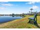 Scenic view of a tranquil pond with lush green surroundings and a bench for relaxation at 108 Pompano Se Dr # A, St Petersburg, FL 33705