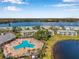 Aerial view of a community with inviting pool area, lush landscaping, and tranquil lake views at 108 Pompano Se Dr # A, St Petersburg, FL 33705