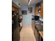 Galley kitchen featuring appliances, tiled floors, ample counter space at 122 Pompano Se Dr # A, St Petersburg, FL 33705