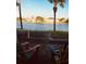 Relaxing lake view from the patio with colorful Adirondack chairs at 122 Pompano Se Dr # A, St Petersburg, FL 33705
