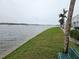 Picturesque waterfront view with palm trees and grassy lawn, offering serene living at 122 Pompano Se Dr # A, St Petersburg, FL 33705