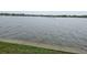 Vast waterfront view with gentle waves, grassy edges, perfect for nature lovers at 122 Pompano Se Dr # A, St Petersburg, FL 33705