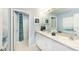 A bathroom showcasing a double vanity, large mirror, and a separate toilet area at 13336 Tropical Breeze Way, Hudson, FL 34669