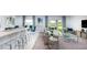 Inviting living space featuring an open floor plan with bar seating and access to the patio at 13336 Tropical Breeze Way, Hudson, FL 34669