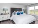 Elegant main bedroom with a tufted headboard, stylish nightstands, and plenty of natural light at 13336 Tropical Breeze Way, Hudson, FL 34669
