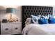 Close-up of a main bedroom showcasing a tufted headboard and decorative nightstand at 13336 Tropical Breeze Way, Hudson, FL 34669