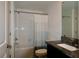 Bathroom featuring white tile tub shower and single sink vanity at 14352 Editors Note St, Ruskin, FL 33573