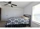 Comfortable bedroom features a ceiling fan and a black and white comforter at 14352 Editors Note St, Ruskin, FL 33573