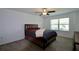 Spacious bedroom featuring modern bed, ceiling fan, and large window at 14352 Editors Note St, Ruskin, FL 33573
