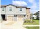 Charming townhouse with stone accents, two-car garage, and well-maintained landscaping at 14352 Editors Note St, Ruskin, FL 33573