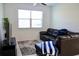 Cozy living room with comfortable seating, a large window, and a modern entertainment center at 14352 Editors Note St, Ruskin, FL 33573