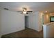 Upstairs loft space featuring carpeted floors, a ceiling fan, and two entryways at 14352 Editors Note St, Ruskin, FL 33573